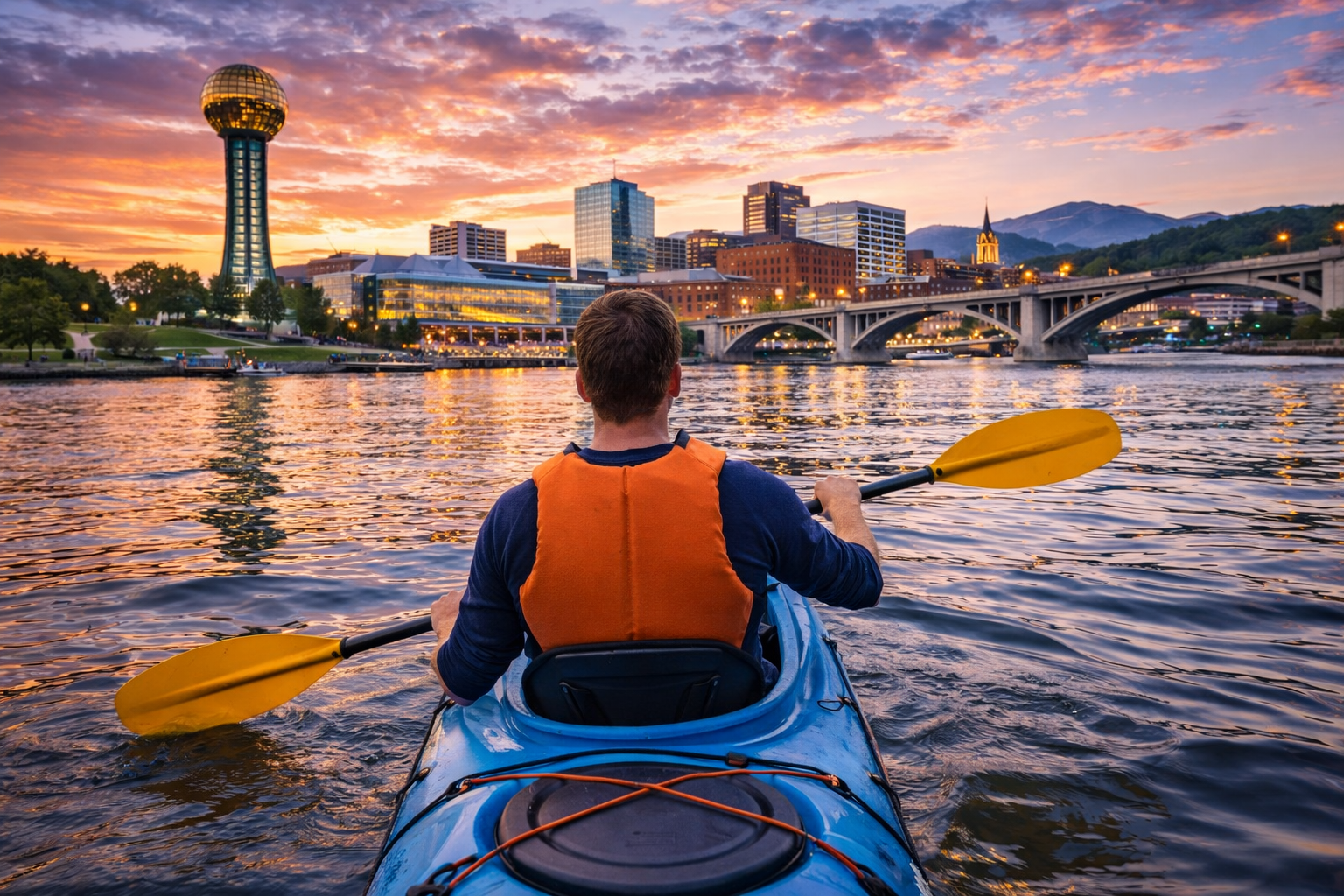 Kayaking towards Knoxville's sunset skyline